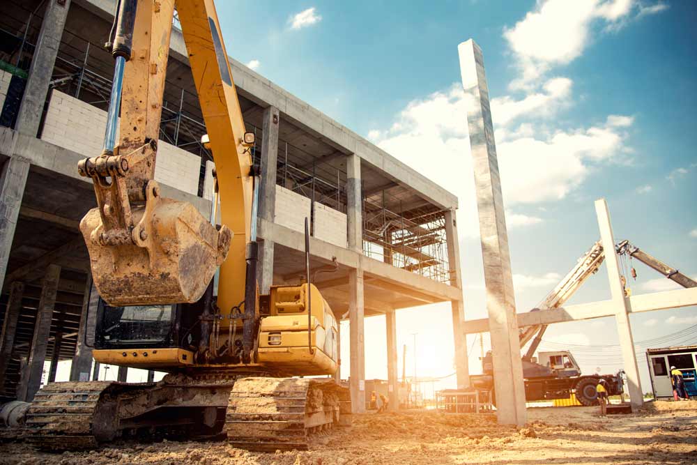 Heavy equipment operators working on building